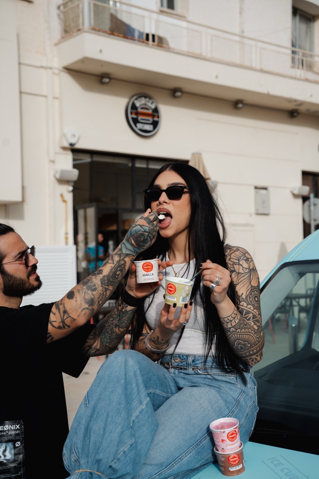 Two friends sharing ice cream outside Burger Stories