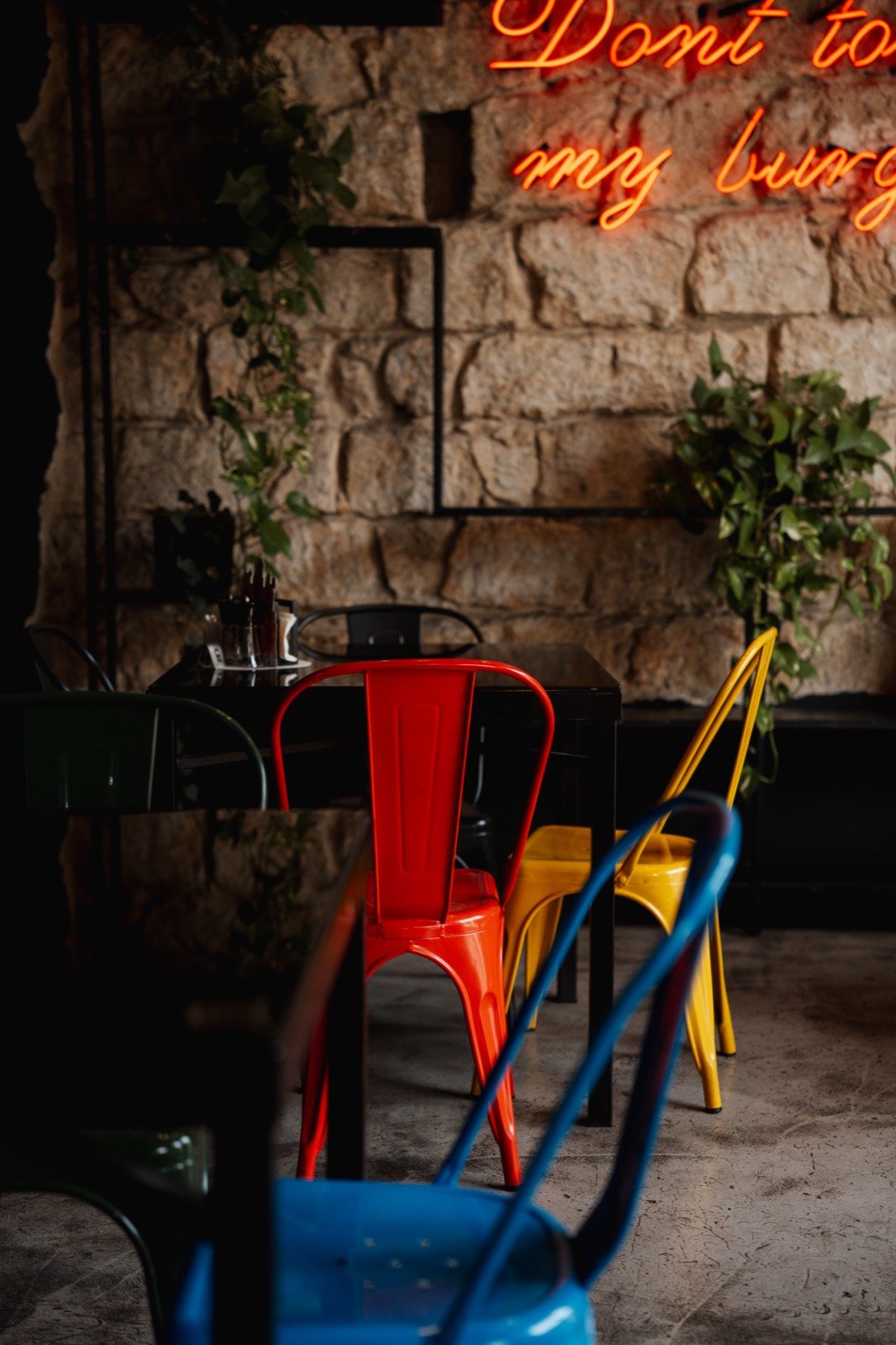 Colorful chairs under the neon sign