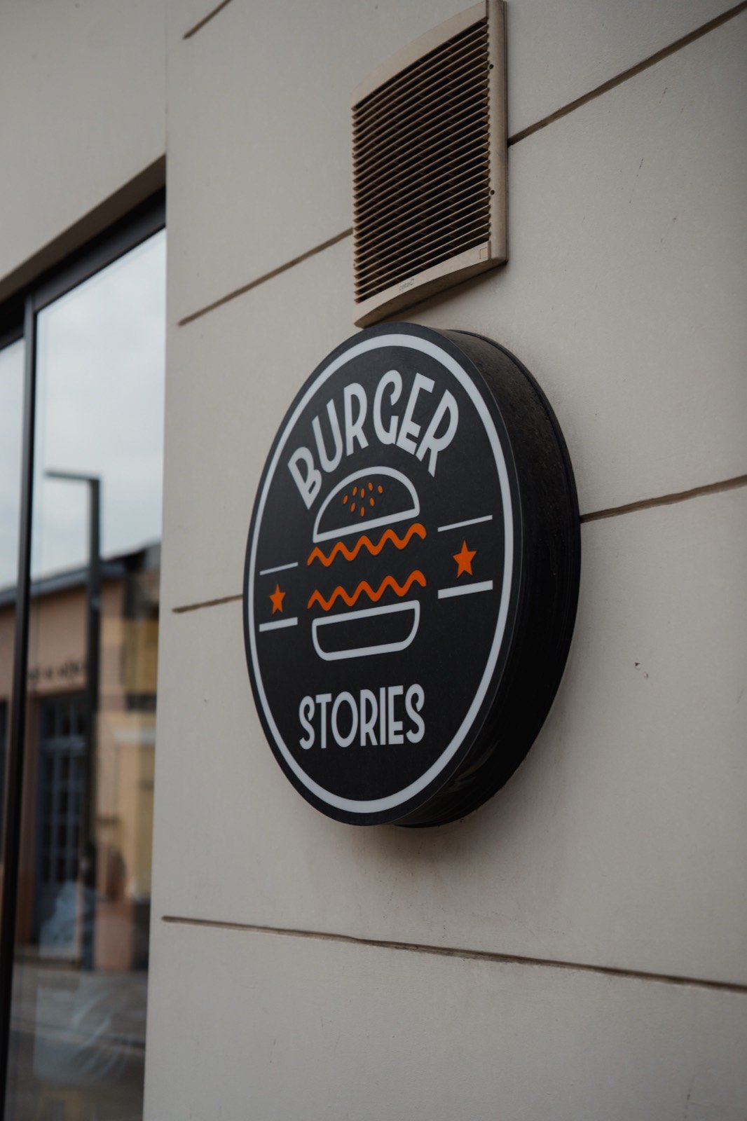 The round Burger Stories sign